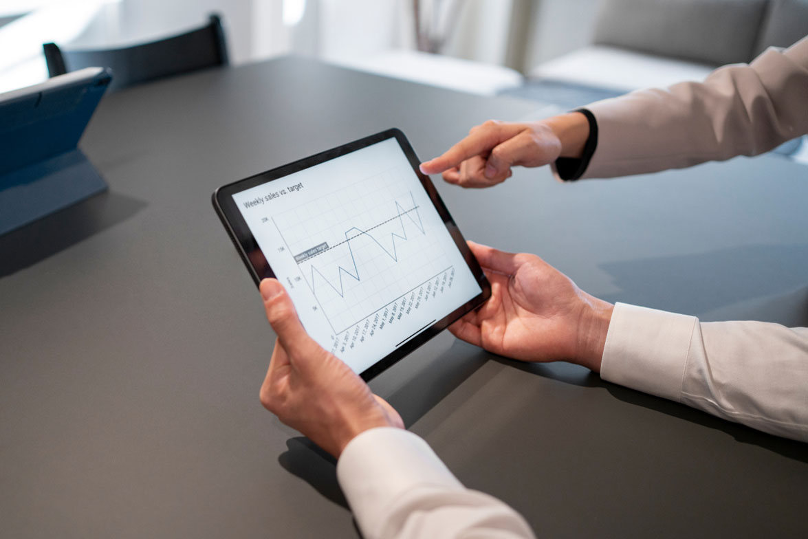 Two business partners working together in office on computer